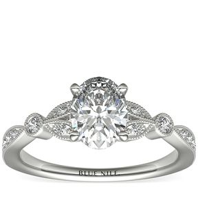 A vintage-inspired engagement ring with a 1-carat oval diamond surrounded by a milgrain edge.